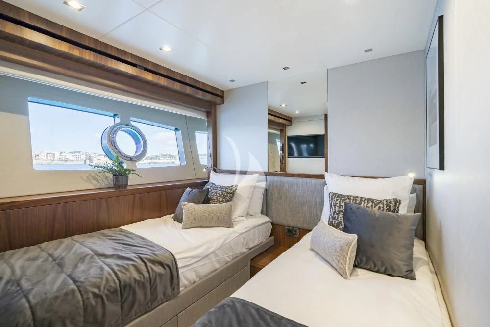 a bedroom with a bed and a large window aboard TAKE OFF Yacht for Sale