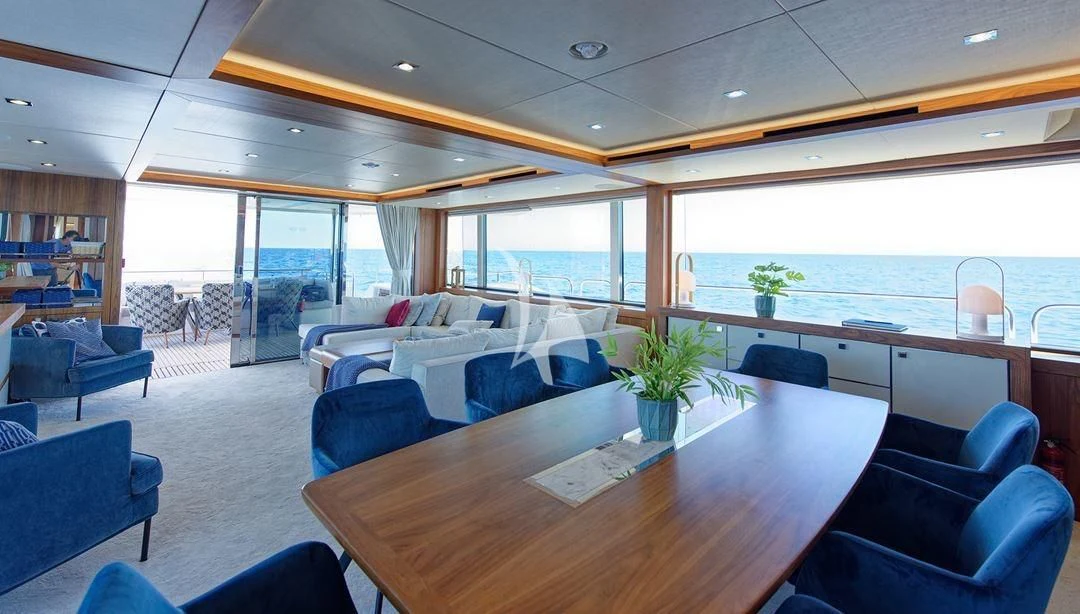 a room with a table chairs and a plant in it aboard TAKE OFF Yacht for Sale