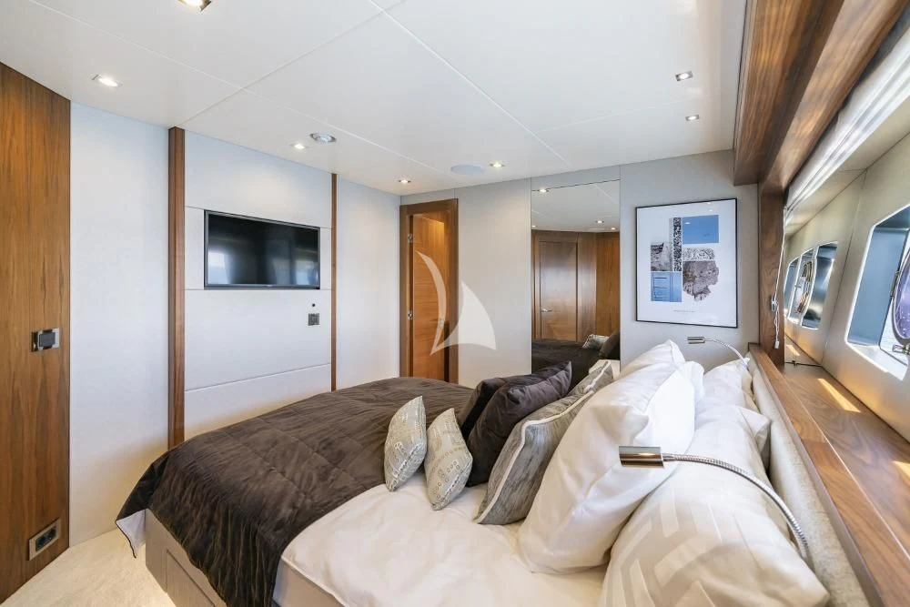 a bedroom with a bed and a television aboard TAKE OFF Yacht for Sale
