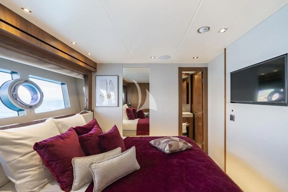a bedroom with a bed and a mirror aboard TAKE OFF Yacht for Sale