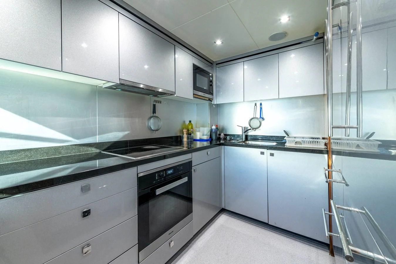a kitchen with white cabinets aboard TAKE OFF Yacht for Sale