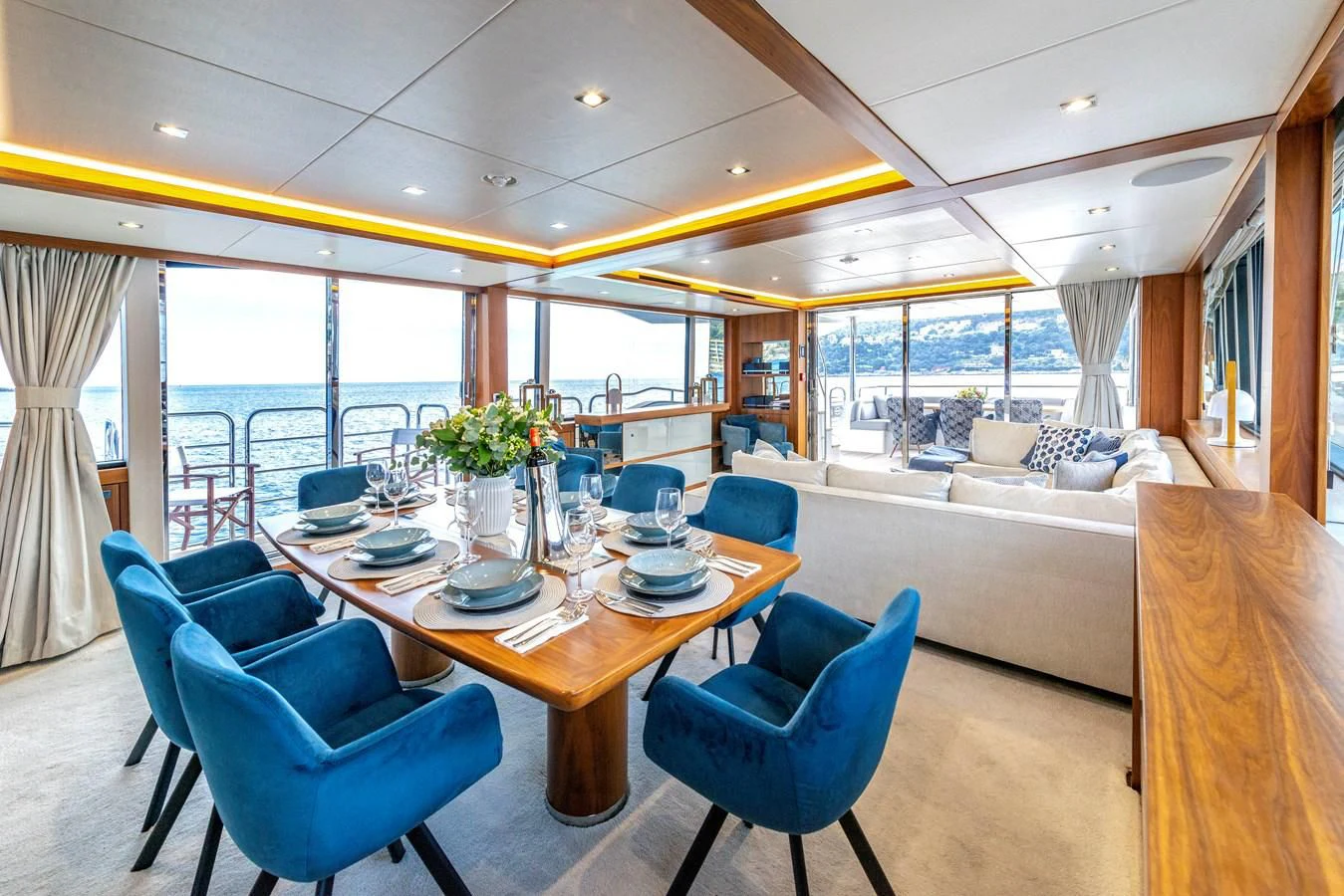 a living room with a large table and chairs aboard TAKE OFF Yacht for Sale