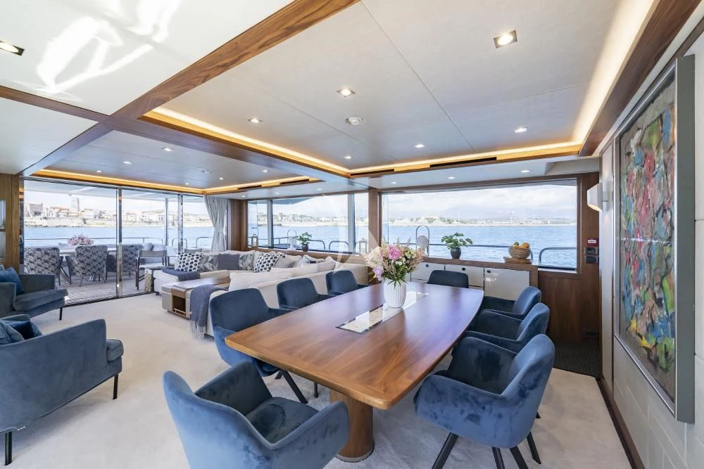 a large room with a table and chairs aboard TAKE OFF Yacht for Sale