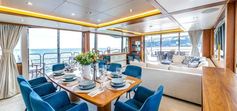 a dining table in a living room aboard TAKE OFF Yacht for Sale