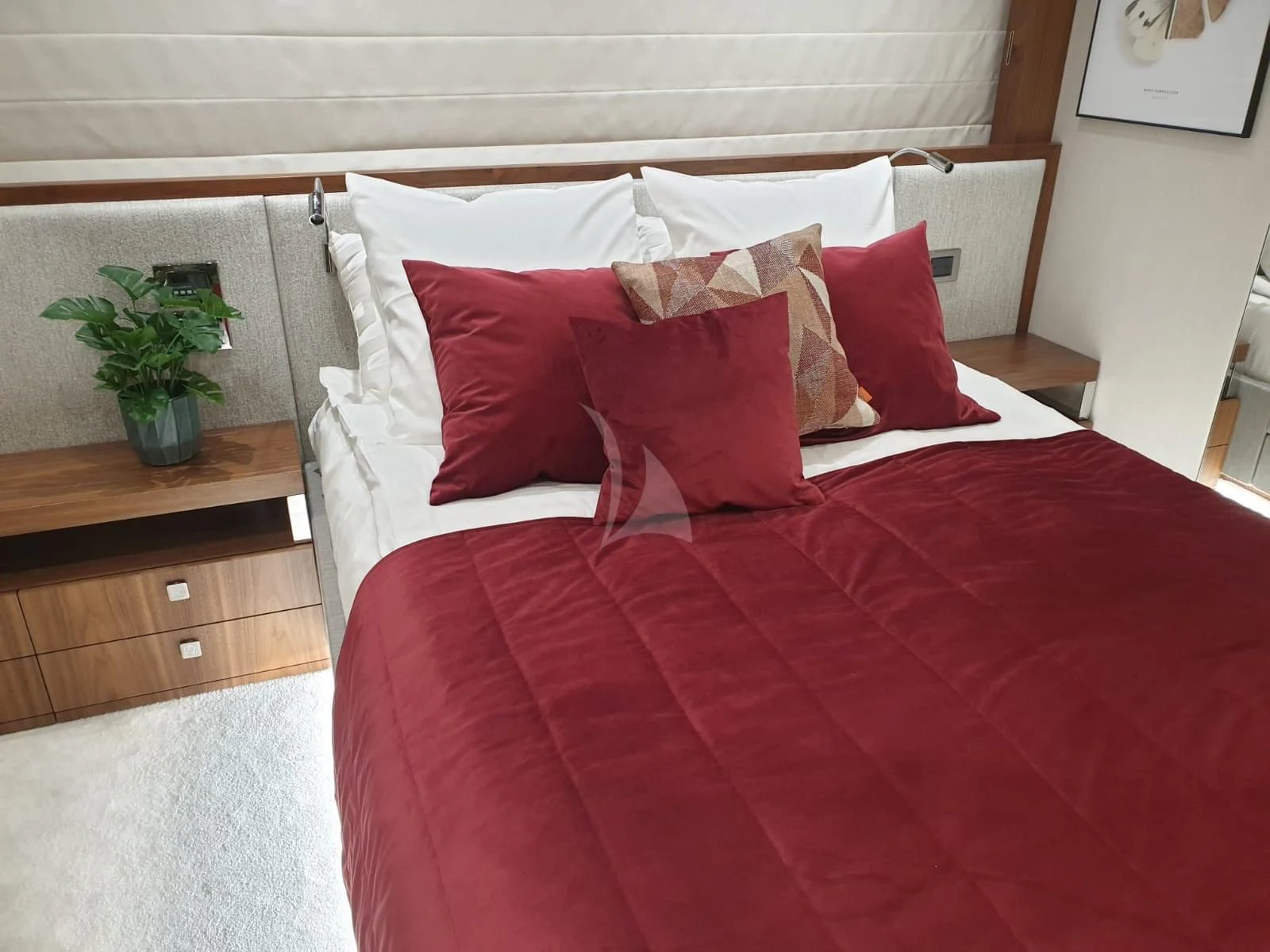 a bed with red pillows aboard TAKE OFF Yacht for Sale