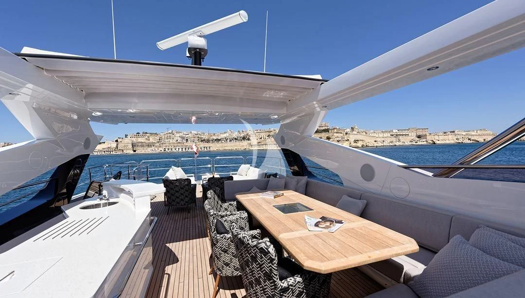 a deck with a table and chairs on it aboard TAKE OFF Yacht for Sale