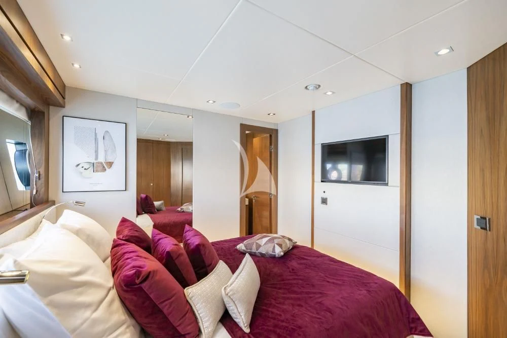 a bedroom with a bed and a television aboard TAKE OFF Yacht for Sale