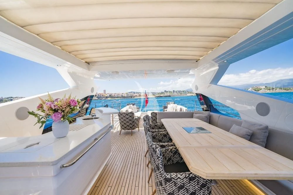 a boat with a table and chairs aboard TAKE OFF Yacht for Sale