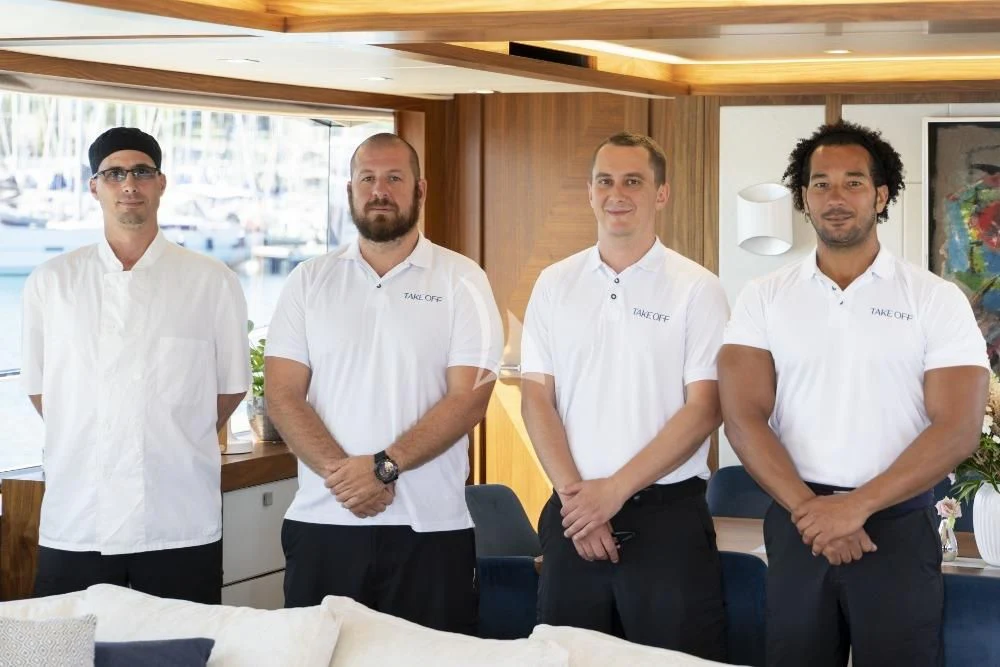 a group of men posing for a photo aboard TAKE OFF Yacht for Sale