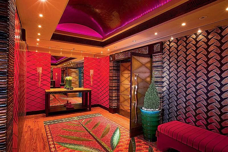 a room with a table and a couch aboard SCENIC ECLIPSE Yacht for Sale