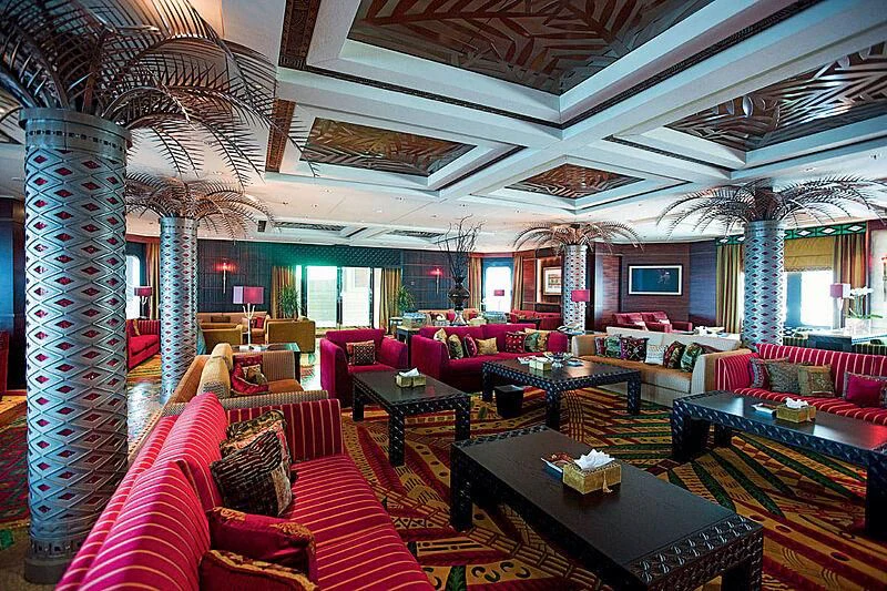 a large living room with a large chandelier aboard SCENIC ECLIPSE Yacht for Sale