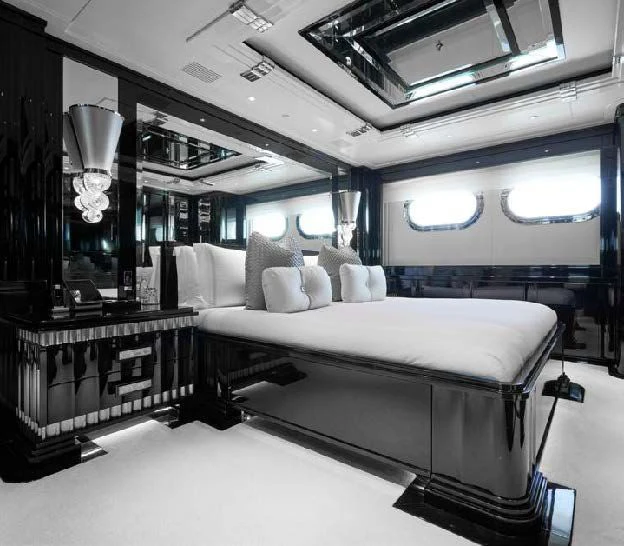 a room with a bed and a mirror aboard SILVER ANGEL Yacht for Charter