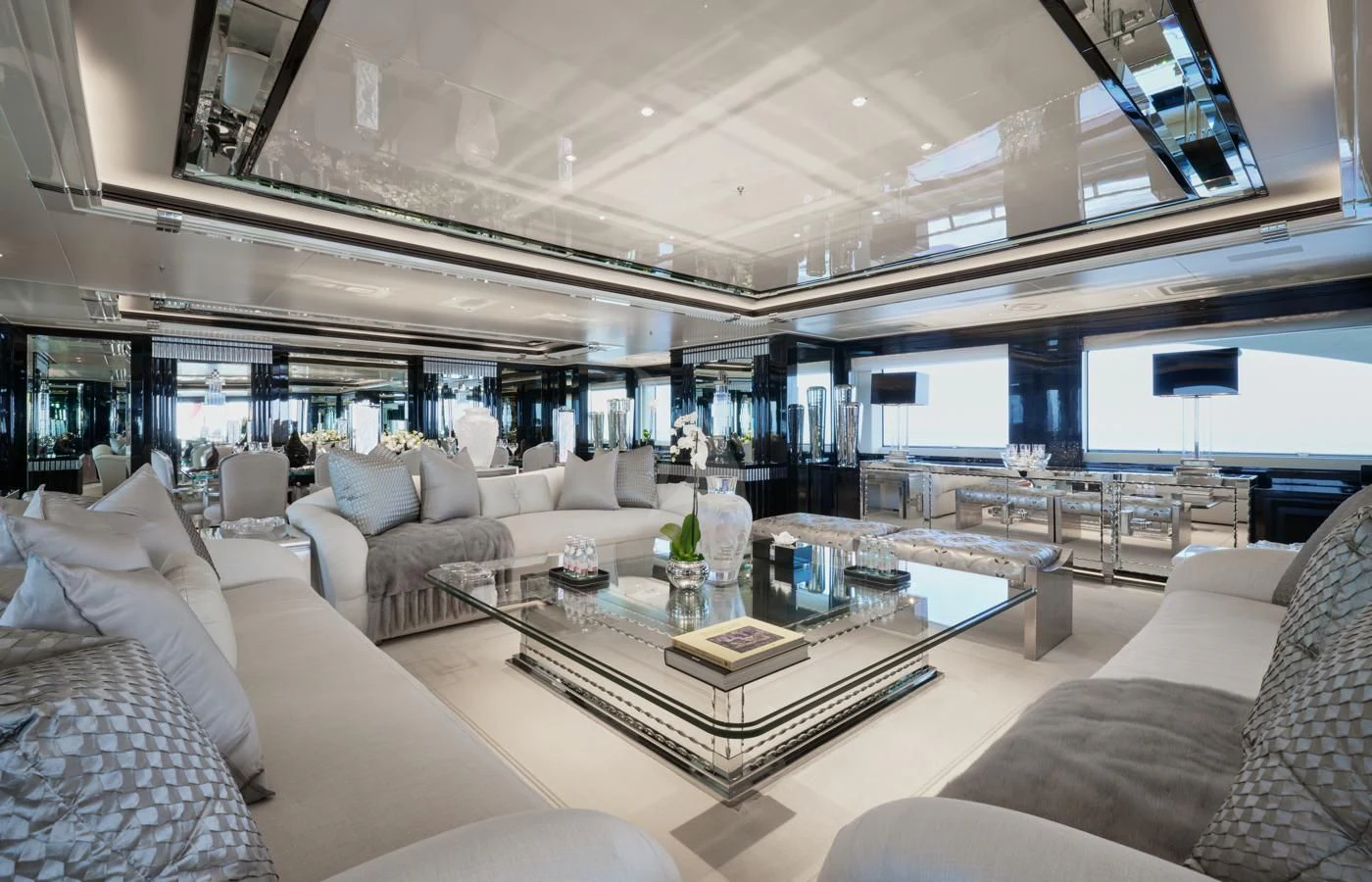 a living room with a large glass coffee table aboard SILVER ANGEL Yacht for Charter