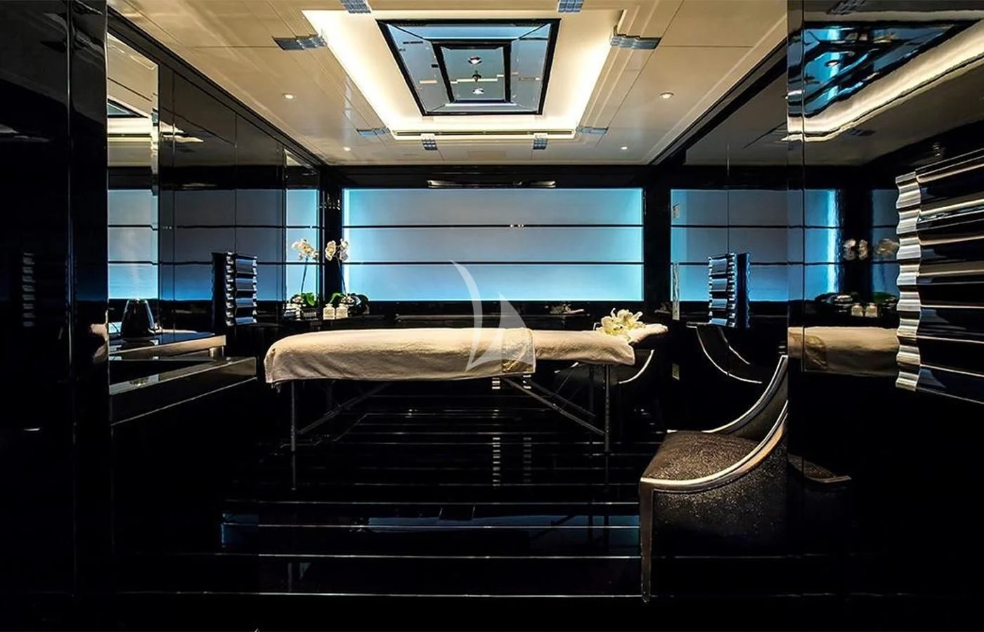 a room with a large mirror and a table with chairs aboard SILVER ANGEL Yacht for Charter