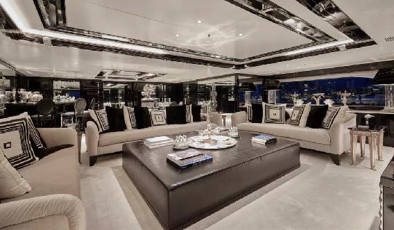 a living room with a large white sofa and a large table aboard SILVER ANGEL Yacht for Charter