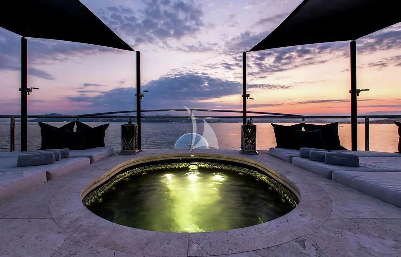 a pool with a view of the ocean and a boat in the background aboard SILVER ANGEL Yacht for Charter
