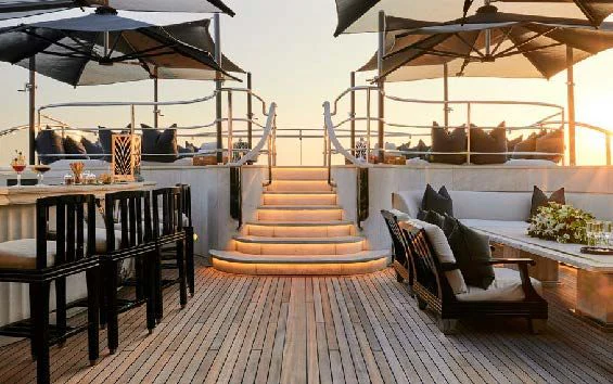 a patio with a table and chairs aboard SILVER ANGEL Yacht for Charter