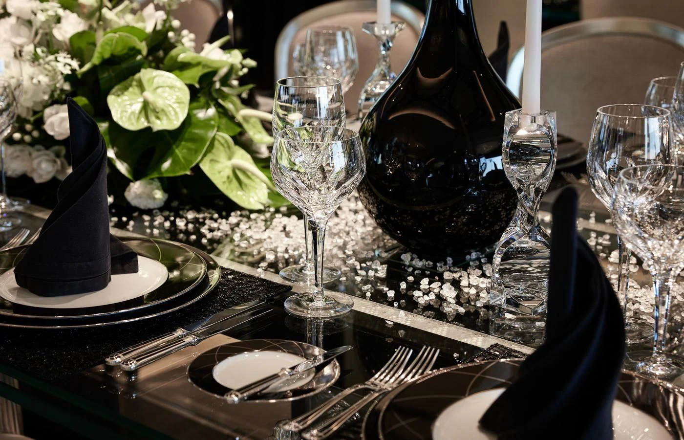 a table with wine glasses and plates aboard SILVER ANGEL Yacht for Charter