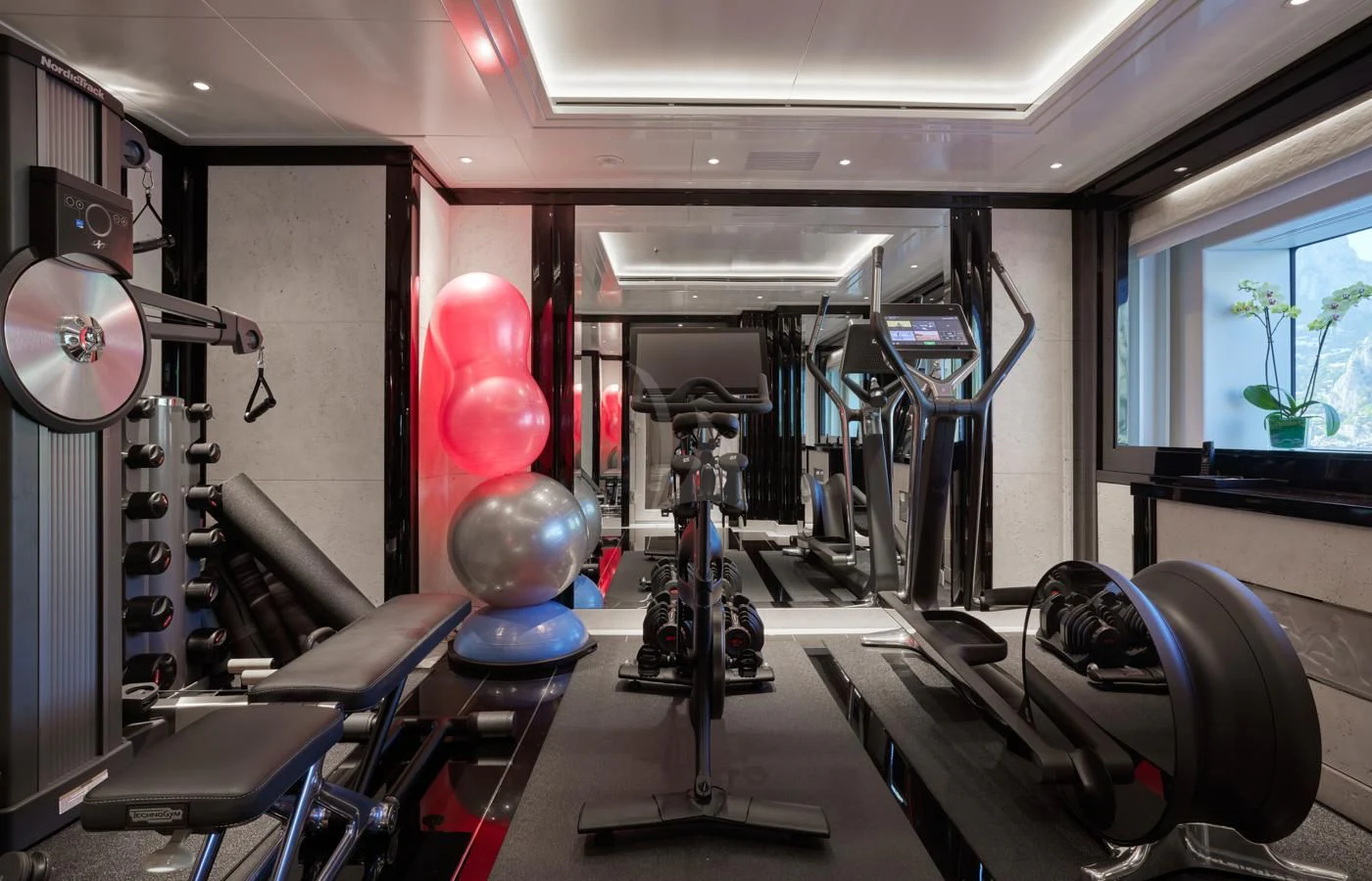 a room with exercise equipment and balloons aboard SILVER ANGEL Yacht for Charter