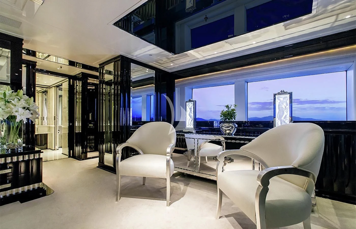 a room with a table chairs and a large window aboard SILVER ANGEL Yacht for Charter