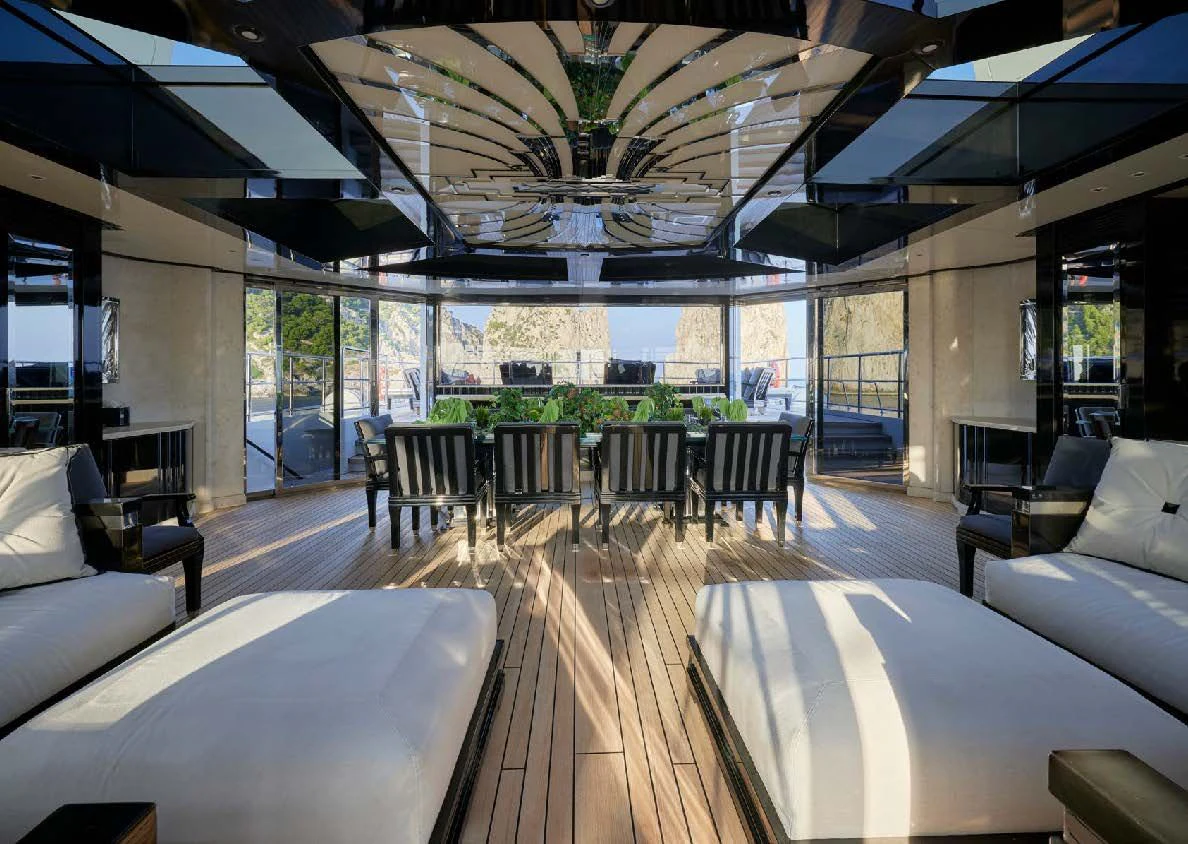 a room with a table chairs and a large window aboard SILVER ANGEL Yacht for Charter