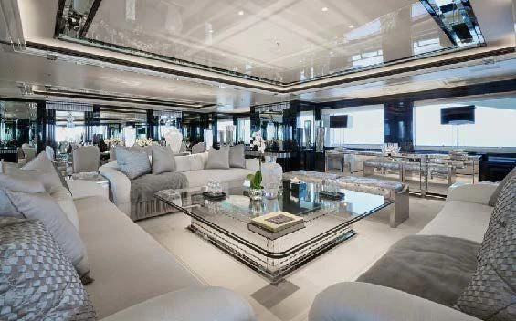 a living room with a large glass table and a large window aboard SILVER ANGEL Yacht for Charter