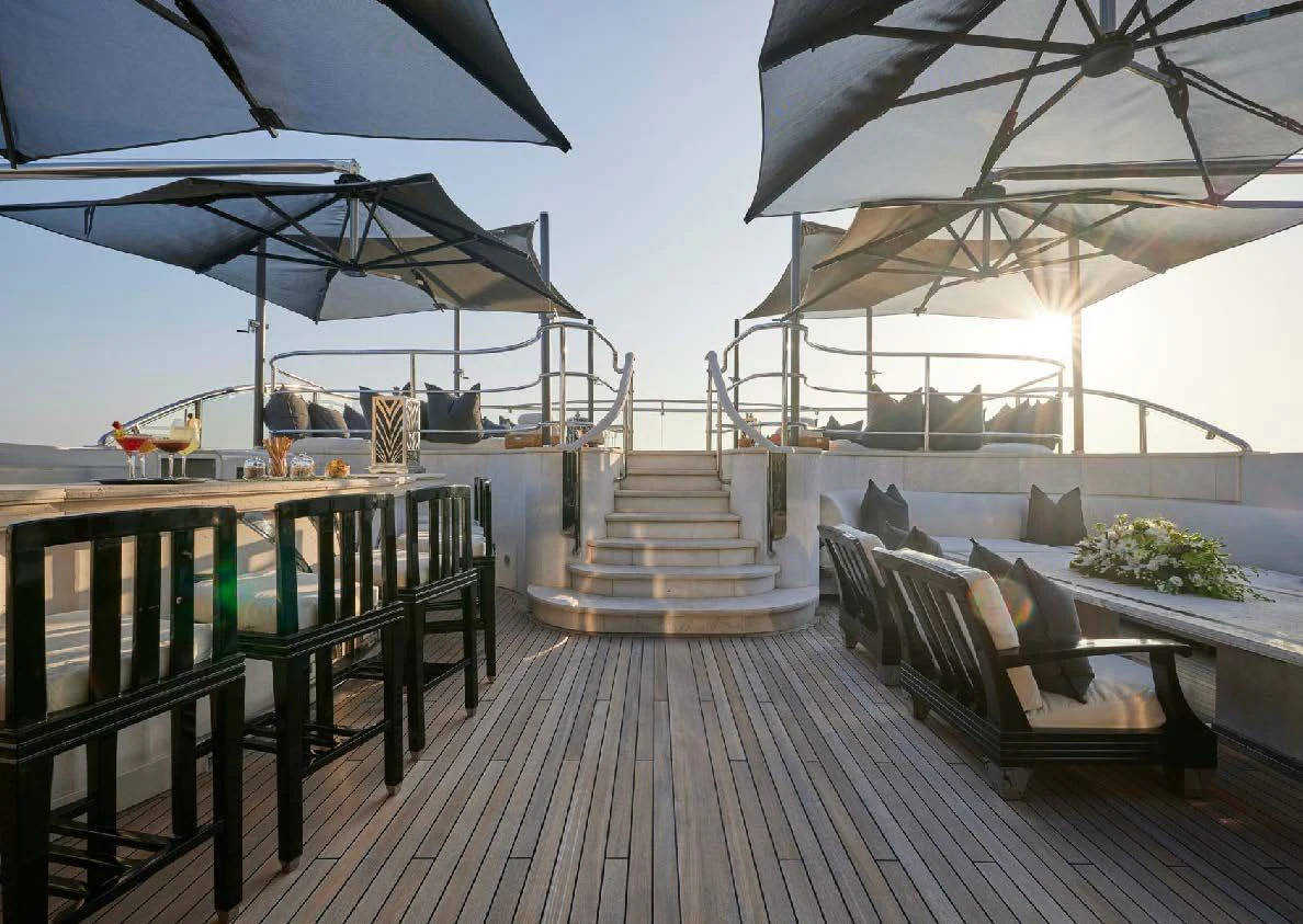 a patio with a table and chairs aboard SILVER ANGEL Yacht for Charter