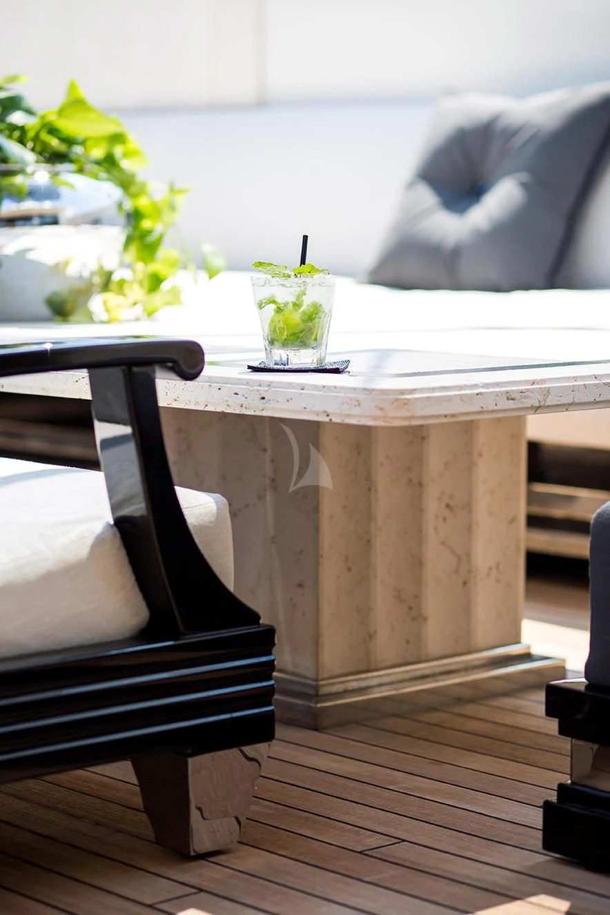 a table with a chair aboard SILVER ANGEL Yacht for Charter