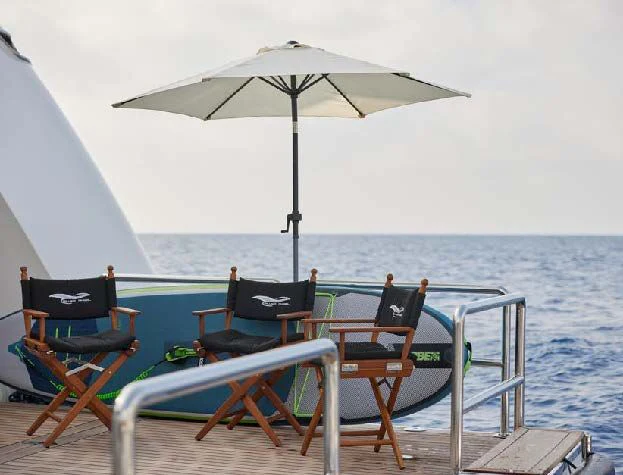 a couple of chairs and an umbrella on a boat aboard SILVER ANGEL Yacht for Charter