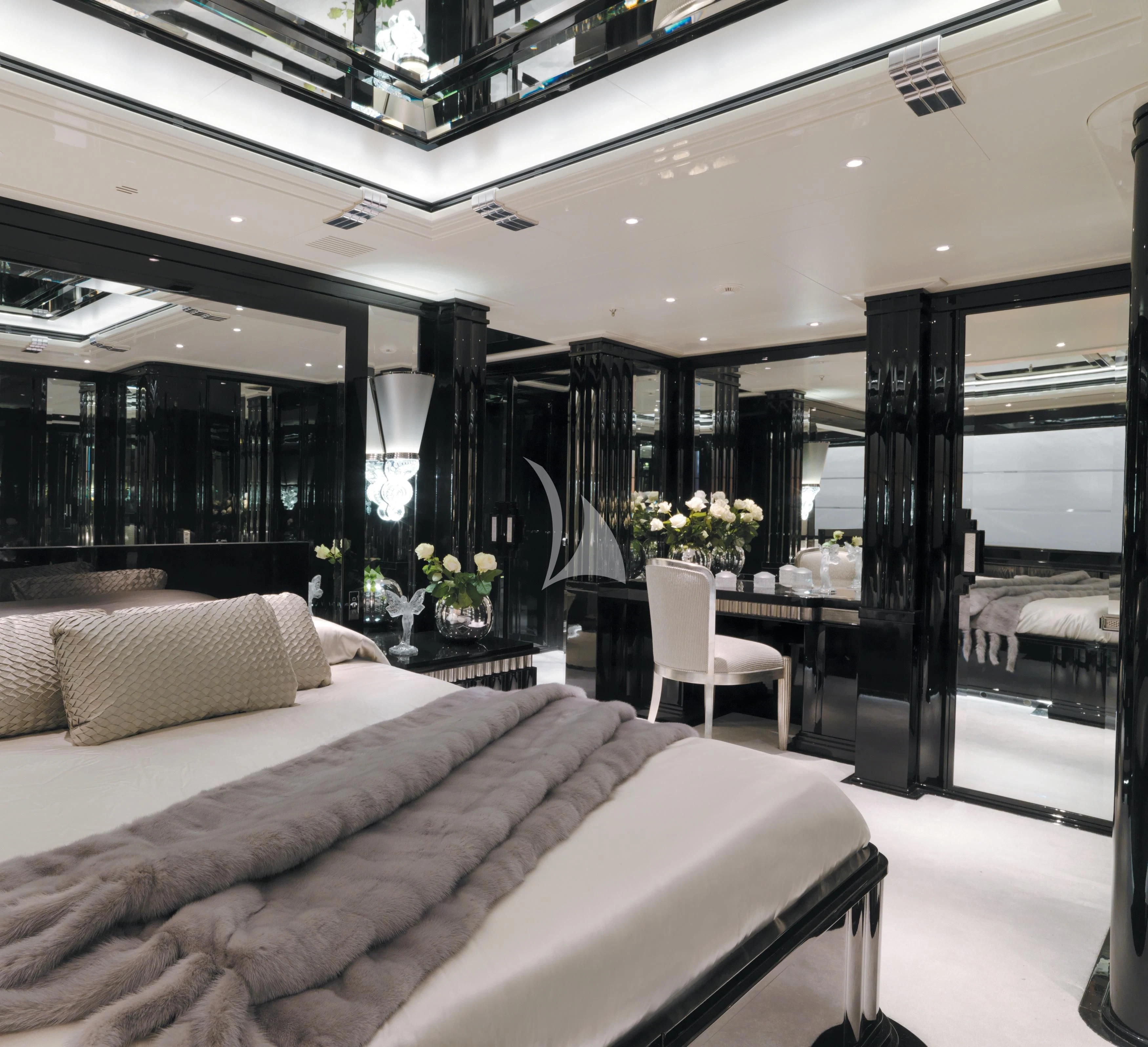 a bedroom with a bed and a chair aboard SILVER ANGEL Yacht for Charter