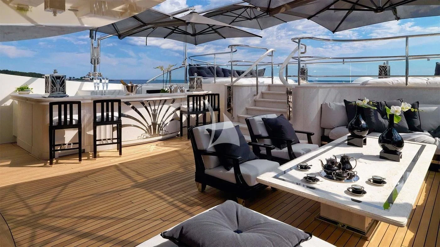 a room with a table chairs and a large window aboard SILVER ANGEL Yacht for Charter