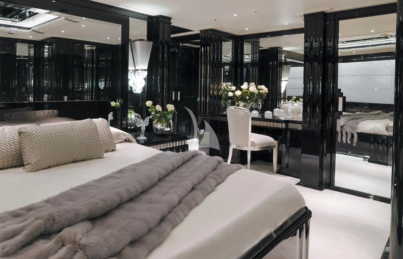 a bedroom with a bed and a chair aboard SILVER ANGEL Yacht for Charter