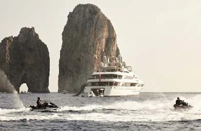a boat in the water with Haystack Rock in the background aboard SILVER ANGEL Yacht for Charter
