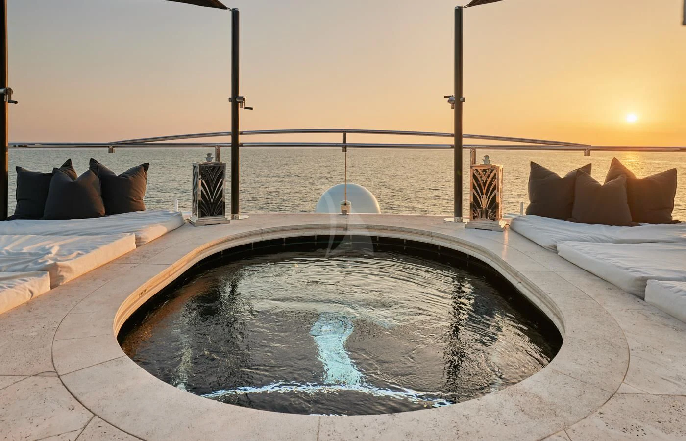 a large bed with a large round pool in front of it aboard SILVER ANGEL Yacht for Charter