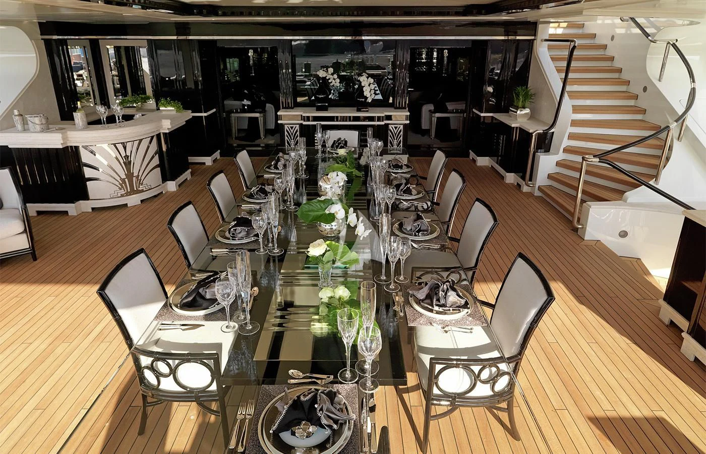a long table with chairs and a set of tables aboard SILVER ANGEL Yacht for Charter