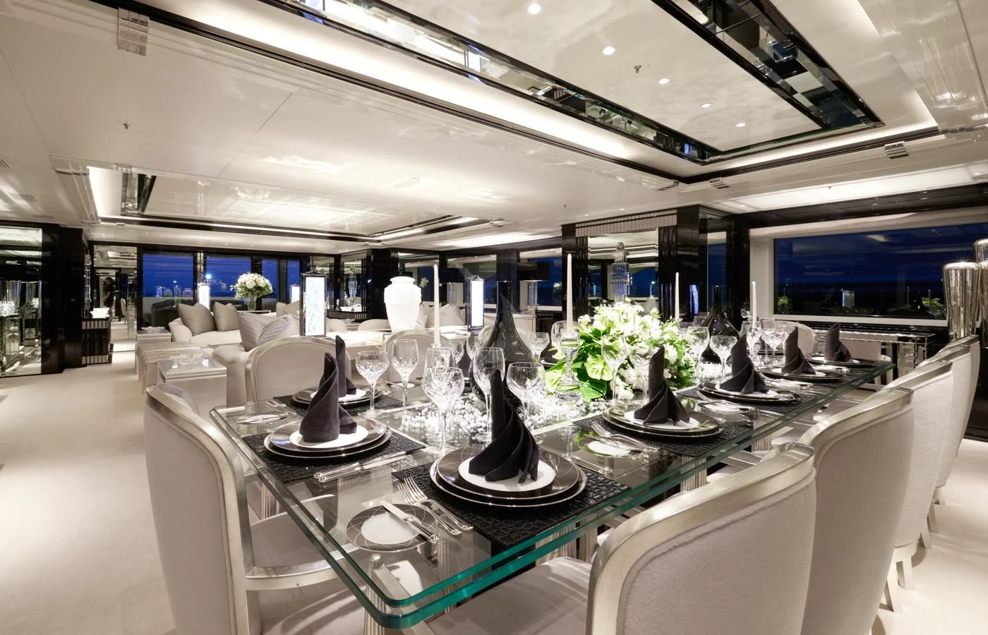 a table with white chairs and black vases on it aboard SILVER ANGEL Yacht for Charter
