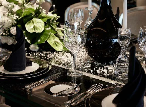 a table with wine glasses and plates aboard SILVER ANGEL Yacht for Charter
