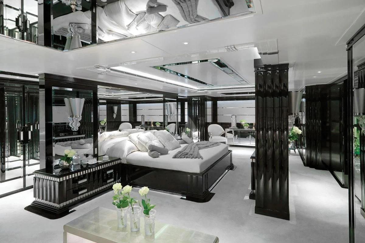 a room with a bed and a table aboard SILVER ANGEL Yacht for Charter