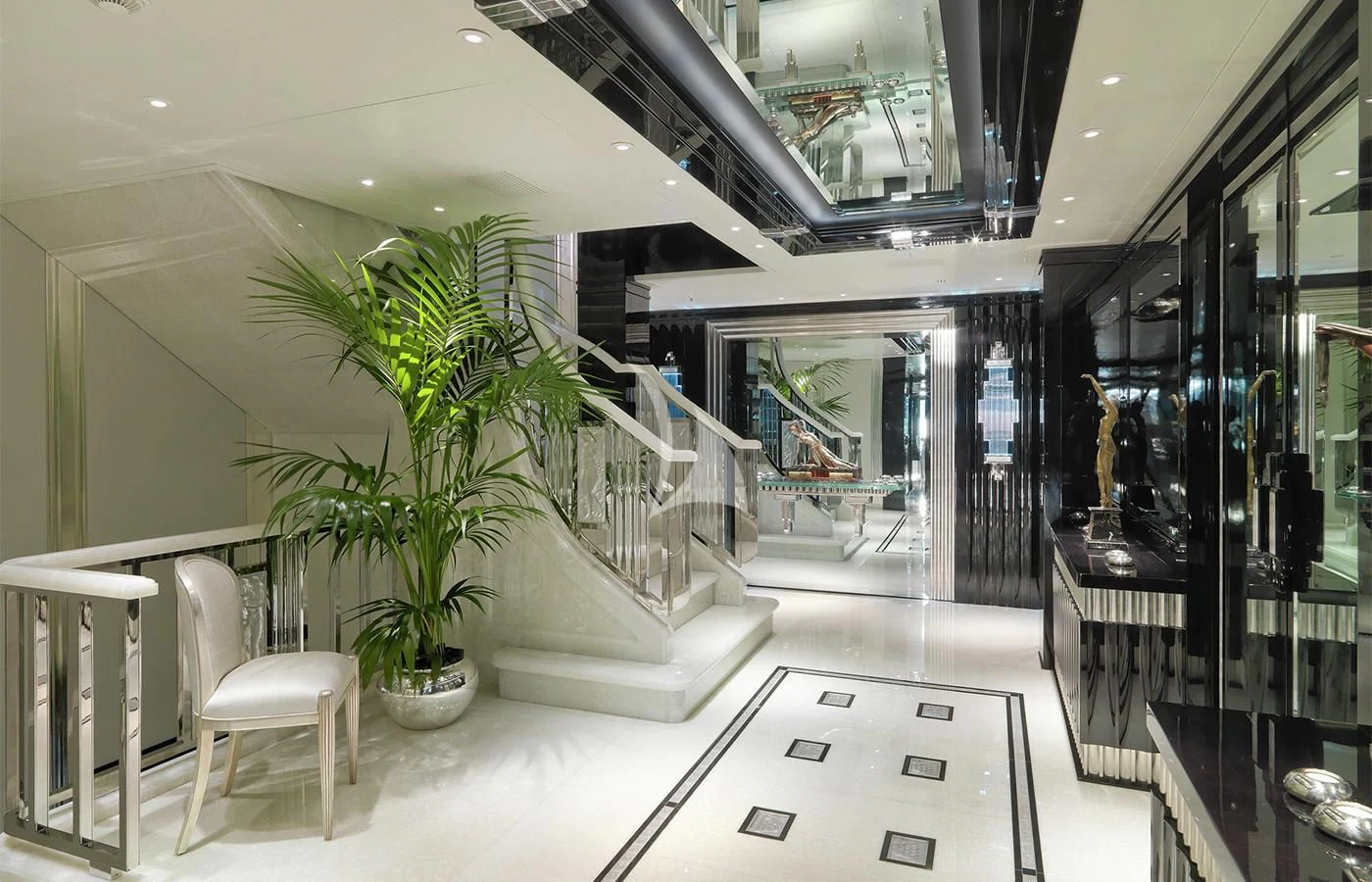 a room with a plant and chairs aboard SILVER ANGEL Yacht for Charter