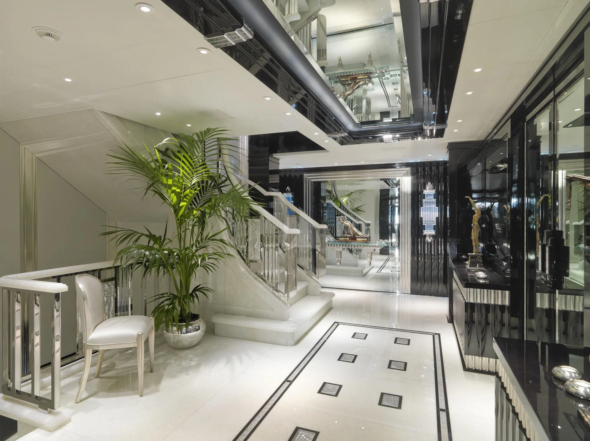 a room with a plant and chairs aboard SILVER ANGEL Yacht for Charter