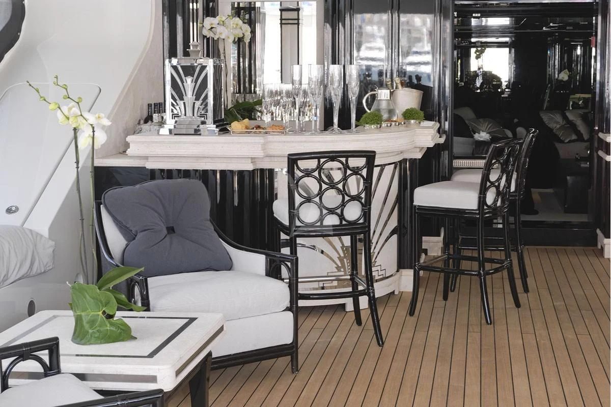 a room with a table chairs and plants aboard SILVER ANGEL Yacht for Charter