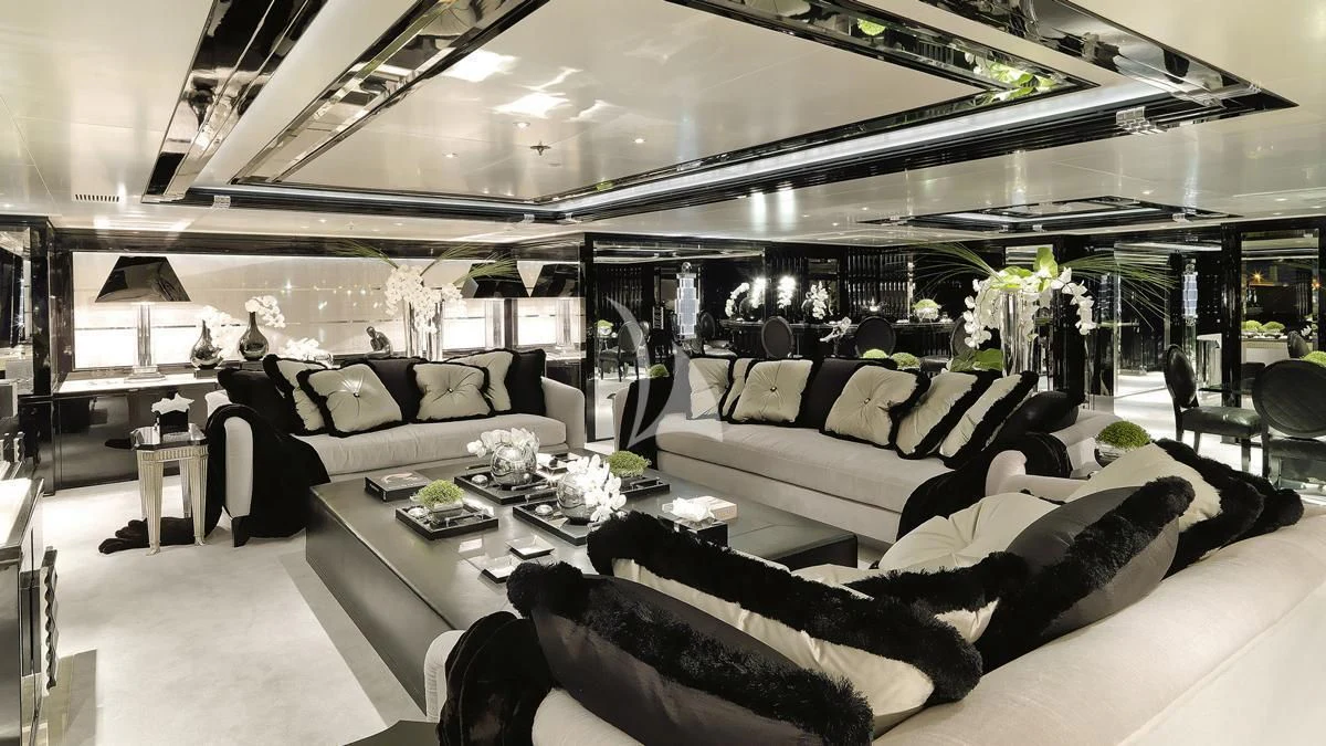 a room with a couch and a table with chairs aboard SILVER ANGEL Yacht for Charter