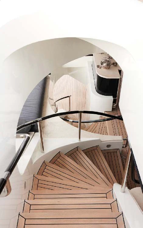 a spiral staircase with a white wall aboard SILVER ANGEL Yacht for Charter