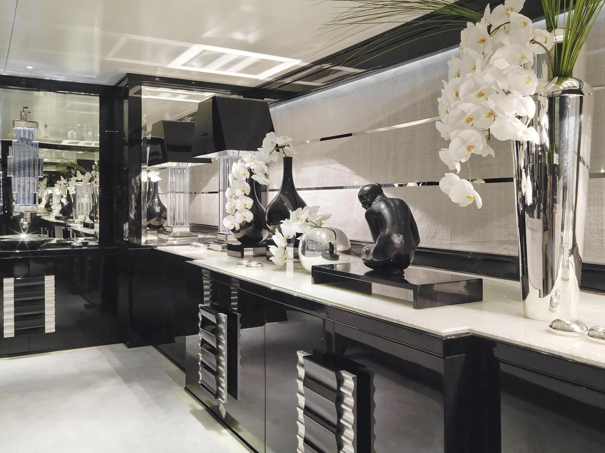 a glass display case with a few statues on it aboard SILVER ANGEL Yacht for Charter