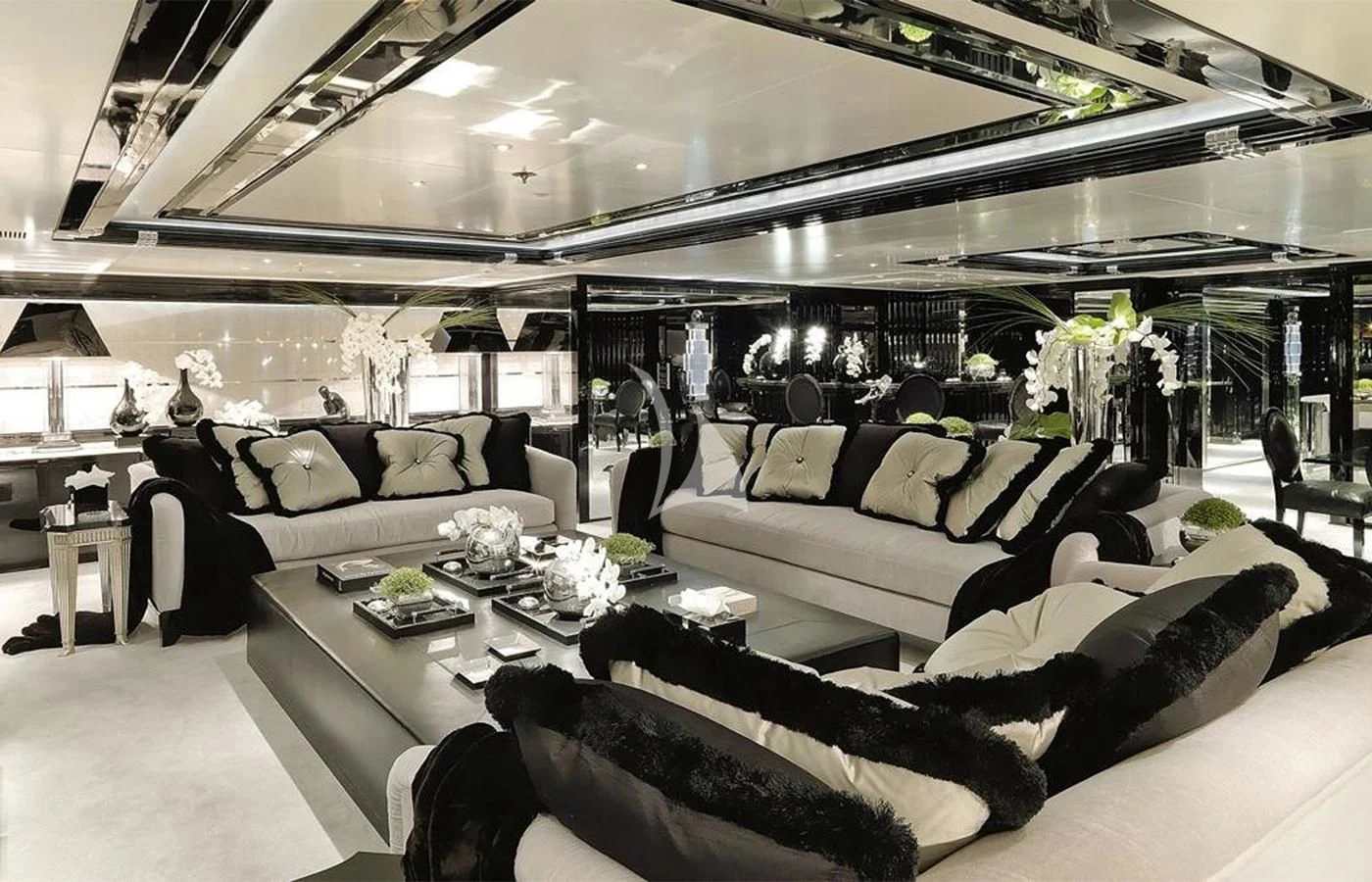 a room with a couch and a table with chairs aboard SILVER ANGEL Yacht for Charter