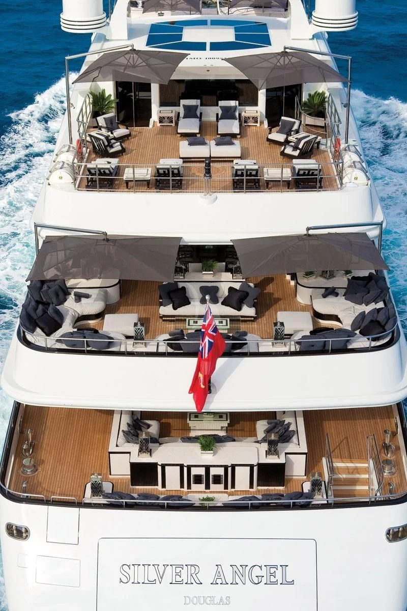 a large white boat with a red sail on it aboard SILVER ANGEL Yacht for Charter