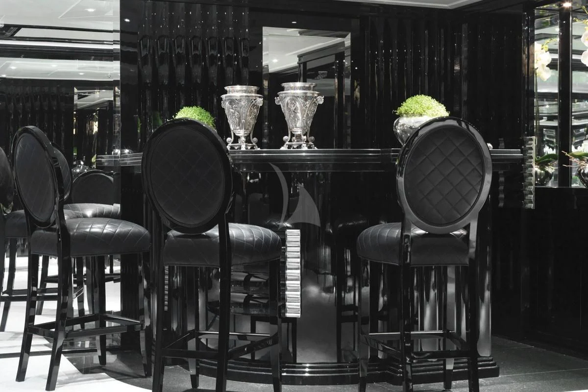 a table with chairs and vases aboard SILVER ANGEL Yacht for Charter