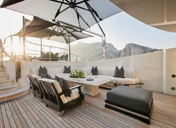 a room with a couch and a table and a large window aboard SILVER ANGEL Yacht for Charter