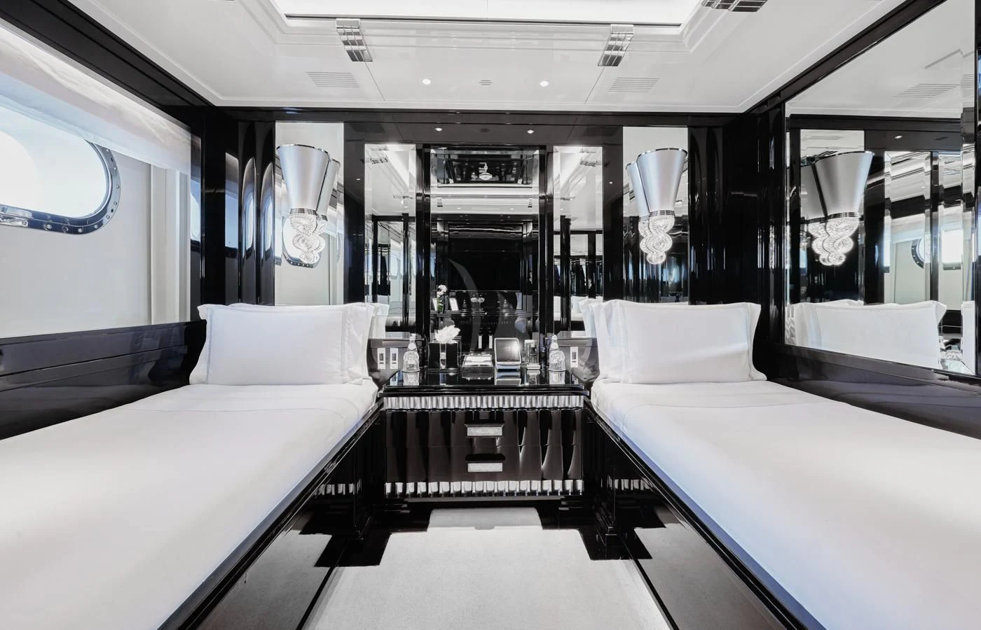 a room with beds and a mirror aboard SILVER ANGEL Yacht for Charter