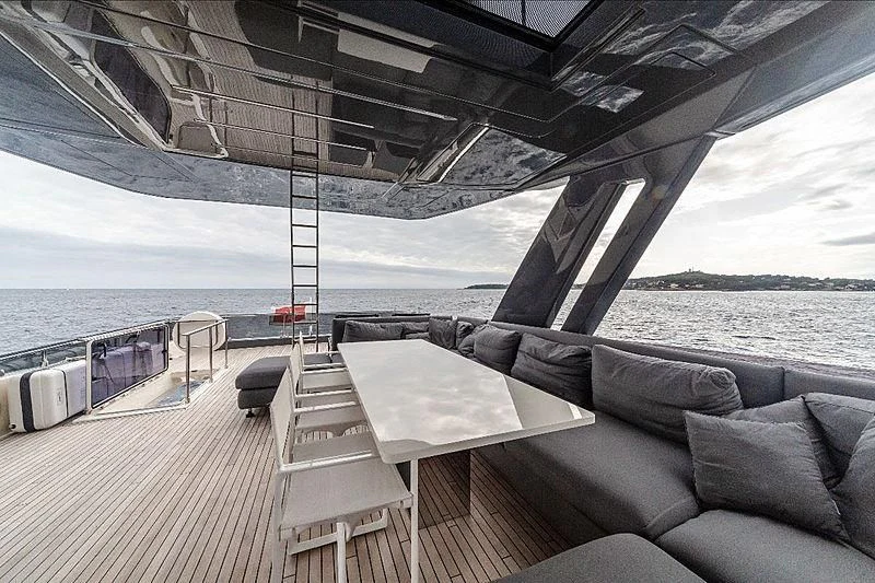 a deck with a couch and a table on it aboard GIO 2 Yacht for Sale